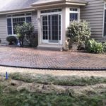 brick patio connected to the back of a home