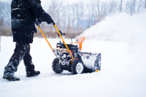 man snow blowing