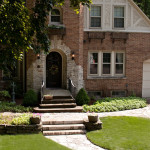 brick house with freshly cut grass