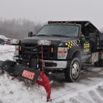 central service truck plowing snow