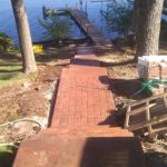 red brick walkway to lake