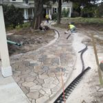 brown and gray brick walkway installation project